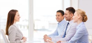 Preparation tips for air hostess interview and cabin crew selection, smiling businesswoman at interview in office